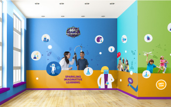 Mad science party room with illustrations on the wall and a picture of a mad scientist and child performing an experiment